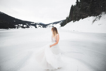 Fototapeta na wymiar Beauty woman, bride with perfect white dress background mountains