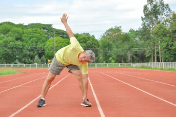 an old man warming up exercise before running or jogging, concept health care in elderly people