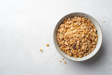 Granola cereal in bowl on concrete background