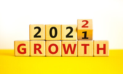 Planning 2022 growth new year symbol. Turned a wooden cube and changed words 'Growth 2021' to 'Growth 2022'. Beautiful white background, copy space. Business, 2022 growth new year concept.