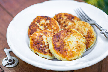 pancakes cottage cheese syrniki sweet breakfast outdoor meal snack on the table copy space food background rustic. top view keto or paleo diet or vegetarian food