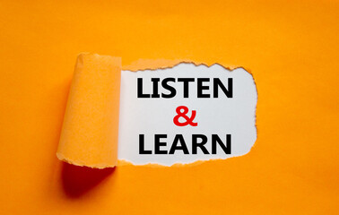 Listen and learn symbol. Words 'Listen and learn' appearing behind torn orange paper. Beautiful...