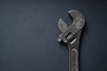 Scary rusty wrench on a dark background with copy space