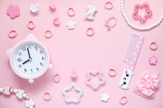 Cute Pink Alarm Clock With Cat Ears And Hair Accessories On Pink Background. Flay Lay, Copy Space