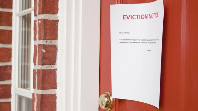 eviction notice taped to a front door of a home