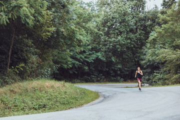 Fototapeta premium Woman running in the woods. Female runner. Run