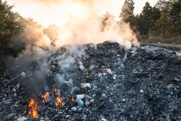 Garbage and fire burn in landfill. Also call trash, waste, rubbish. Destruction with combustion,...
