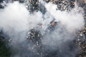 Garbage and fire burn in landfill. Also call trash, waste, rubbish. Destruction with combustion, heat, flame. Occurs smoke, toxic cause of air pollution, environmental damage and global warming. - obrazy, fototapety, plakaty