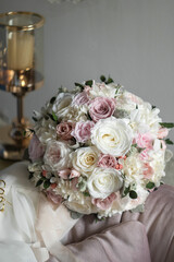Stylish bridal bouquet of preserved flowers. Wedding bouquet of white and pink roses. Close up of wedding bouquet.