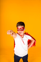 a boy in a hero costume hurries to help on a yellow background with a place for text