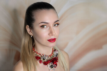 Beautiful woman skincare concept. Bright makeup shades shadows sequins. Perfect hairstyle brushed long straight hair. background horizontal banner. Big massive accessory. Red lips, new crimson flowers