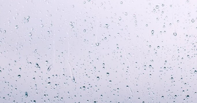 rain drops runnin down the window glass at rainy day
