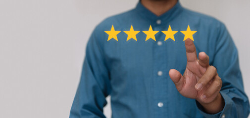 Businessmen wearing a light blue shirt to selecting the level of satisfaction score icons with copy...