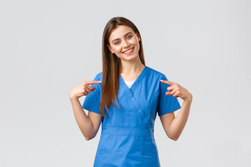 Healthcare workers, prevent virus and medicine concept. Cheerful, smiling pretty doctor, female...