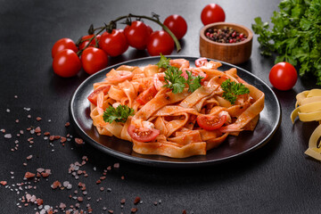 Fettuccine pasta with shrimp, cherry tomatoes, sauce, spices and herbs