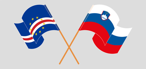 Crossed and waving flags of Cape Verde and Slovenia