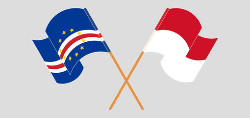 Crossed and waving flags of Cape Verde and Indonesia