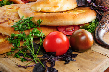 Traditional Georgian adjara khachapuri and Kolkh khachapuri on the table. Assorted Georgean bread.