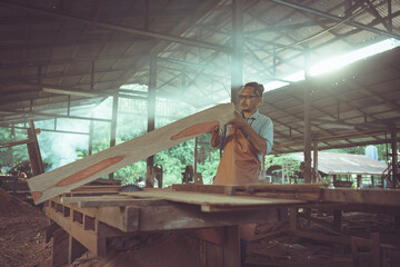 Professional carpenter working in the factory