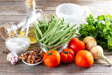 Ingredients for cooking lobio of green beans with vegetables and tomato. Step by step recipe.