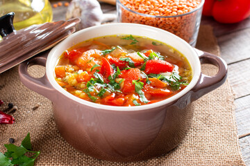 Red soup with lentils and vegetables on a table. Healthy food, healthy food.