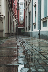 empty narrow passage between buildings, streets after the rain
