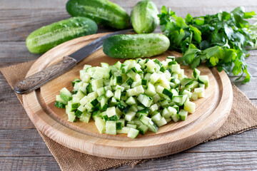 Fresh sliced green cucumbers on a cutting board on a table. Healthy vegetarian ingredient