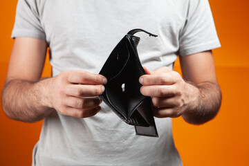 man showing empty wallet