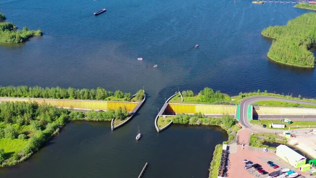 Aquaduct Veluwemeer, Nederland. Aerial view from the drone. A sailboat sails through the aqueduct on the lake above the highway. High quality 4k footage