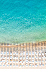 View from above, stunning aerial view of a white sand beach bathed by a turquoise water and relaxed...