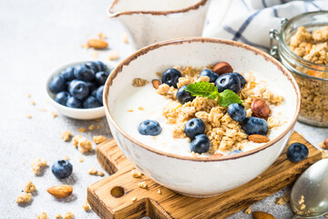 Obraz na płótnie Canvas Yogurt with granola and fresh berries at stone table. Healthy food, snack or breakfast.