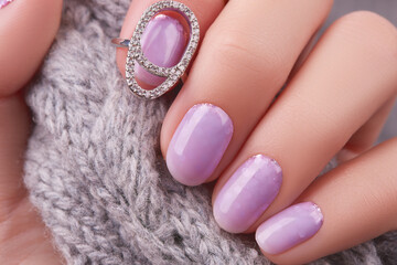Womans hand with fashionable lavender manicure. Winter christmas nail design