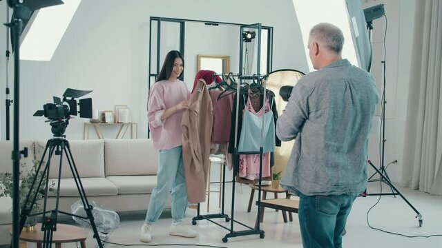 Female model is picking clothes during the photoshoot