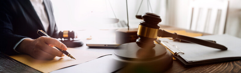 Business and lawyers discussing contract papers with brass scale on desk in office. Law, legal services, advice, justice and law concept picture with film grain effect