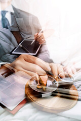 Senior stylish woman taking notes in notebook while using laptop at home. Old freelancer writing details on book while working on laptop in living room. Focused cool lady writing notary in notepad.
