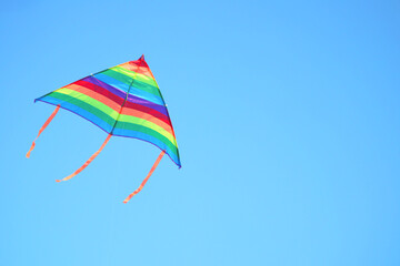 Multicolor kite in blue sky