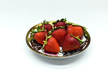 Strawberries in a plate on a white background