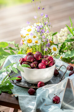 Delicious ripe sweet cherries on summer terrace