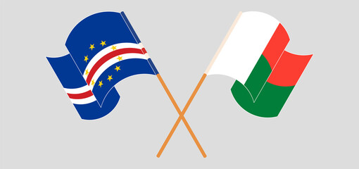 Crossed and waving flags of Cape Verde and Madagascar