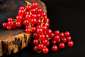 Fresh red currants on dark rustic wooden table. Red currant berries.