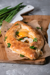 Ajara khachapuri on a wooden Board