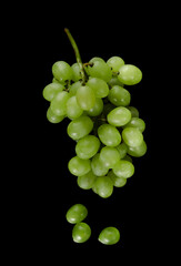 White pouring grapes, with large cubes on a black background isolated