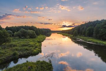 Naklejka na ściany i meble The view of the Viliya river in the forest. The sunset over the river. Nature landscape in Belarus