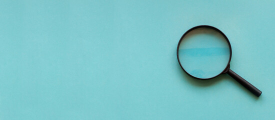 magnifying glass magnifier loupe search symbol on blue background with copy space