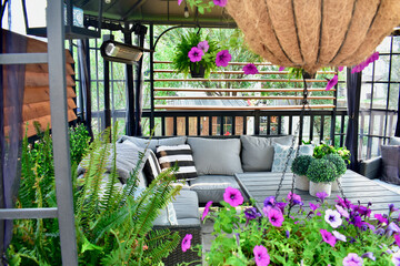 Sheltered outdoor summer lanai living space for relaxing on warm days in backyard oasis or tropical...