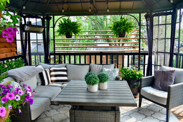 Sheltered outdoor summer lanai living space for relaxing on warm days in backyard oasis or tropical...