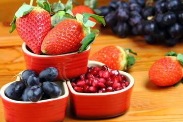 fresh healthy strawberries pomegranate seeds and grapes