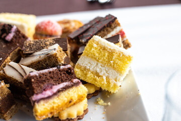 Assorted fruit cakes for holiday. Desserts with fruits, mousse, biscuits