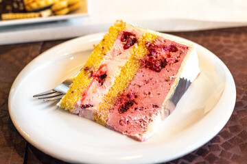 Piece of berry cake dessert, served on the white plate.