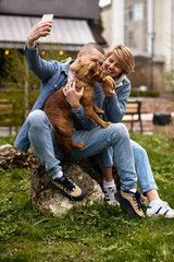 young family walking a dog